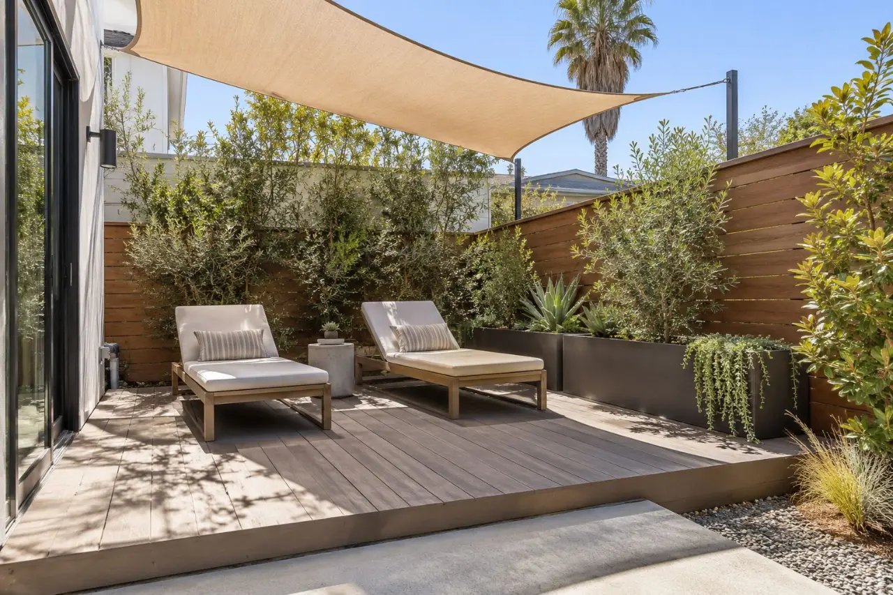 Compact deck with lounge chairs and a shade sail